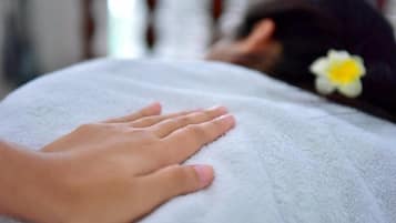 A foot resting on a white towel.