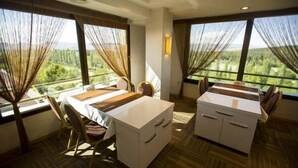A hotel room with a dining area, a bed, and large windows with curtains. - Altinpark Hotel (Kayseri)