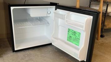 An open refrigerator with a control panel and a label inside.
