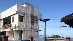 A building with a sign reading "Beach Resort Extension" and a pool area. - Nipa Hut Villa by AMCO Extension (Baler)