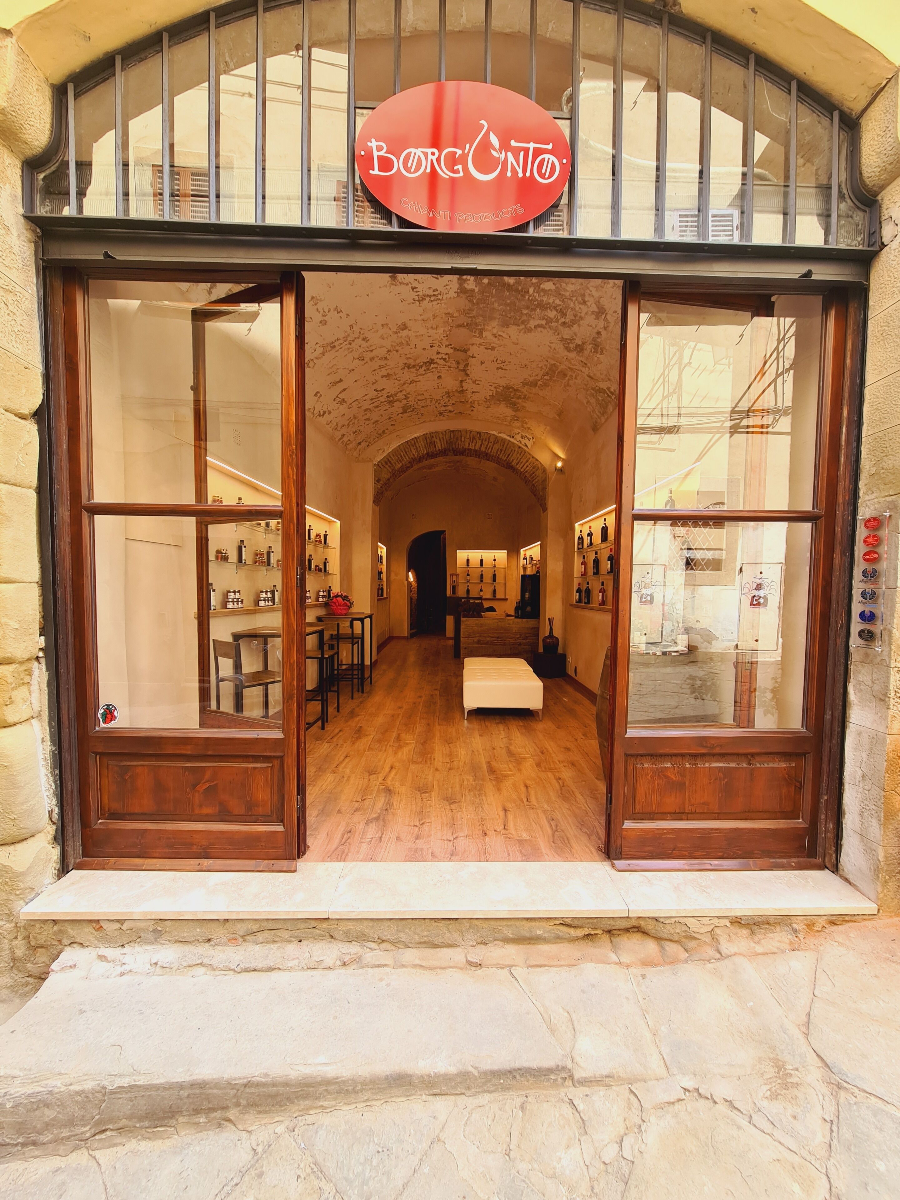 A storefront with a wooden facade and a large arched entrance.