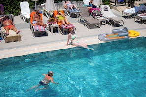 Seasonal outdoor pool, pool umbrellas, pool loungers