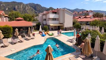 Seasonal outdoor pool, pool umbrellas, pool loungers
