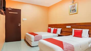 A hotel room with two beds, a wardrobe, and a wall-mounted picture.