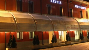 A building with "ALBERGO SAVOIA RISTORANTE" signage, featuring a covered outdoor area with potted plants and a canopy. - Hotel Savoia (Poggio Rusco)