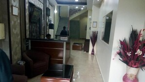 A hotel lobby with a reception desk, a staircase, and a reception area. - Hotel Ikram (Algiers)