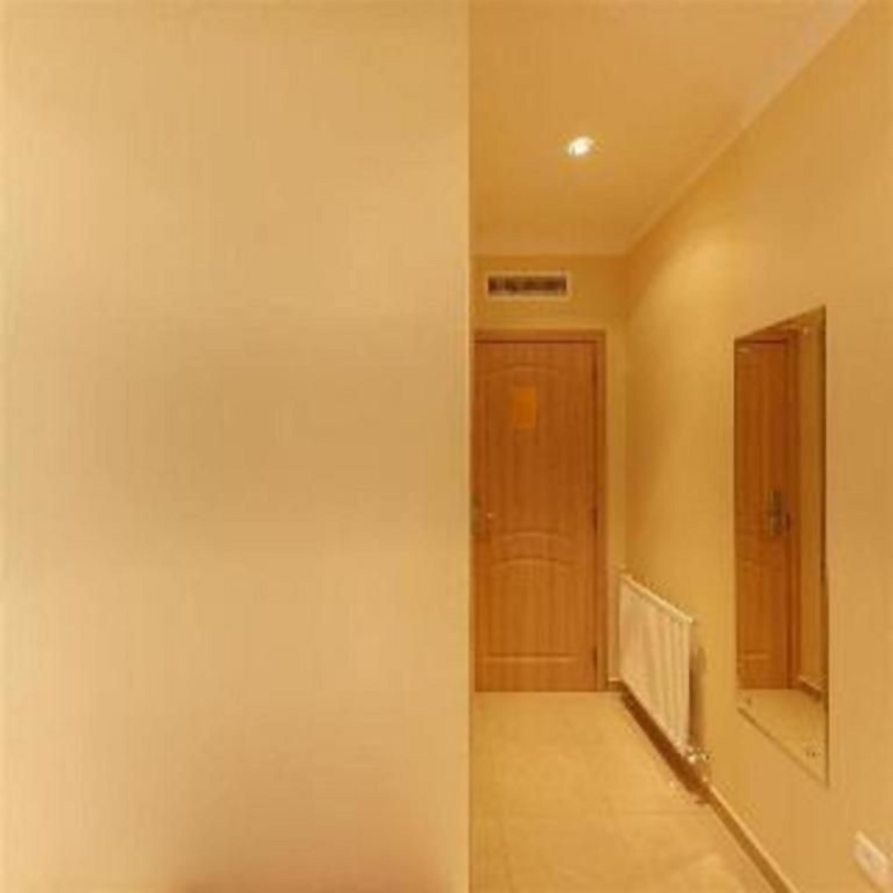 A hallway with a wooden door and a radiator.