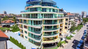 Een hotel met meerdere verdiepingen, balkons en een helder uitzicht op de omliggende stad.