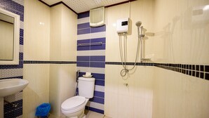 A bathroom with a toilet, sink, and shower.