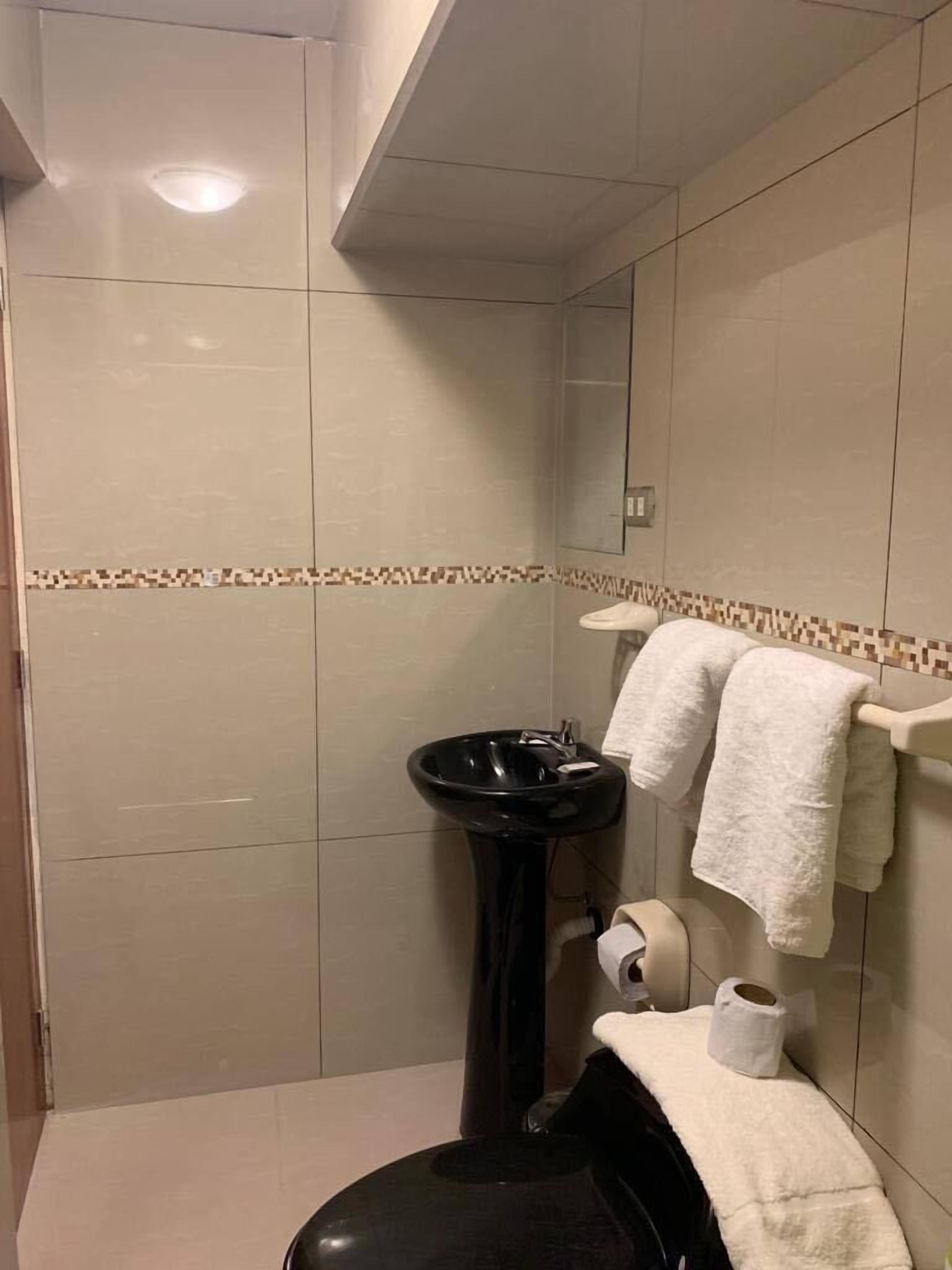 family room, 2 double beds, air conditioning, city view | bathroom | shower, towels