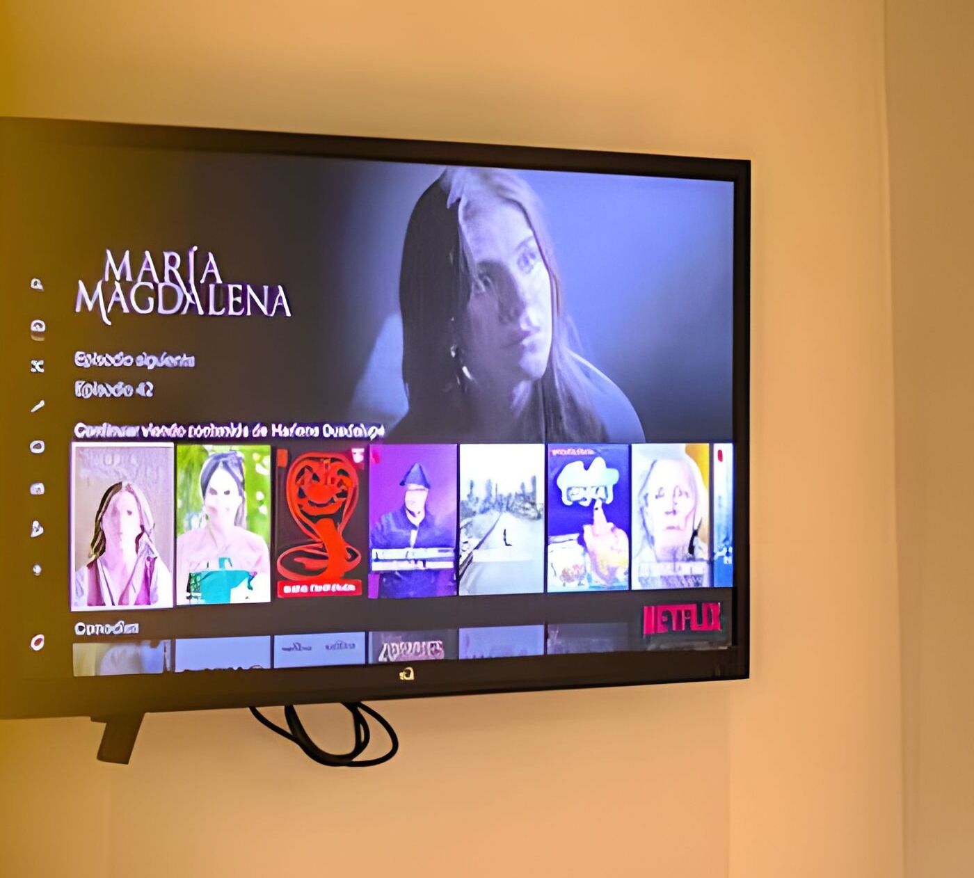 A television displaying a streaming service interface with various content options.