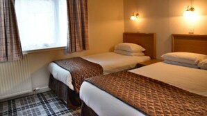 A hotel room with two beds, a window with curtains, and two wall-mounted lights. - Tongadale Hotel (Portree)
