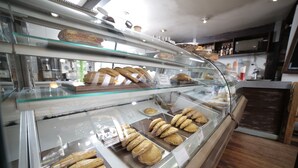 A bakery display case with various baked goods. - Hotel Villa Mayor (Cusco)