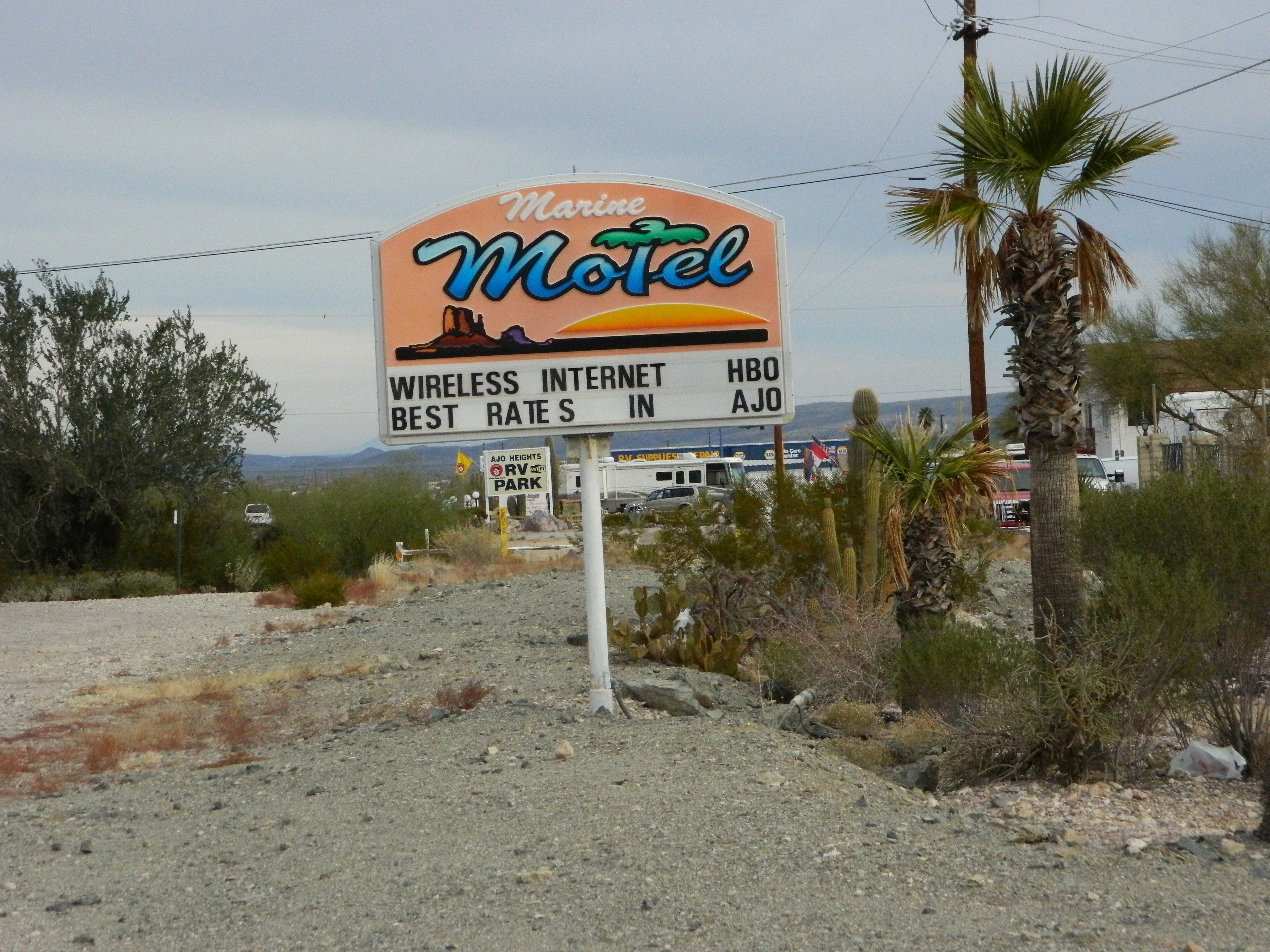 A sign for a motel with amenities including wireless internet, HBO, and the best rates in Ajo.