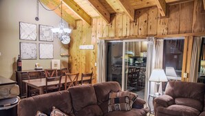 A cozy wooden interior with a sofa, chairs, a dining table, and a kitchen area. - Lake Views! Perfect Mountain Summer Get-a-way No traffic, 8,000 ft. elevation (Stateline)