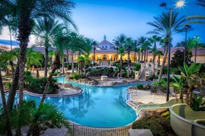A resort with a central pool, palm trees, and a building with a dome roof.