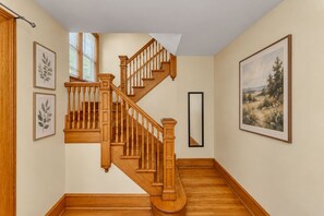 As you enter the apartment you are welcomed by the beautiful wood work of the staircase. - After the Game Apt 1 - All Star Baseball Rentals (Oneonta)