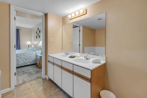 Enjoy a convenient bathroom with a dual sink vanity, large mirror, and ample storage.