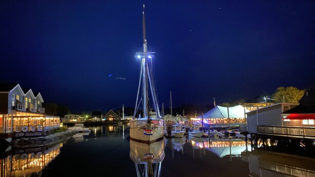 A marina at night with boats docked, a tall structure with lights, and buildings with illuminated signs. - Booking now Winter Rental Sept 2026-May 2027. Please message for monthly prices (Kennebunkport)