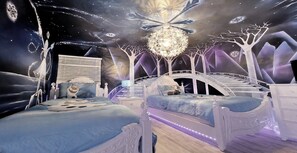 A bedroom with a bed, a nightstand, and a dresser.
