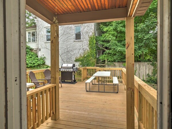 A wooden deck with a grill, chairs, and a picnic table. - 1st Base Apt 2 - All Star Baseball Rentals (Oneonta)