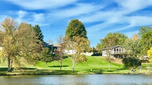A lakeside property with multiple houses, a grassy area, and trees. - Quiet, relaxing home on Lake Watab in beautiful St. Joseph, MN near SJU and CSB (St Joseph)