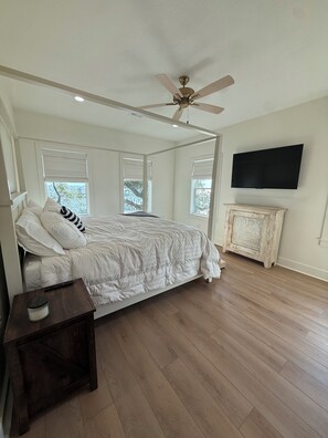 A bedroom with a bed, a ceiling fan, a TV, and a wooden cabinet. - ON THE ROCKS 2.0 BIG LAKE 🎣 (Lake Charles)