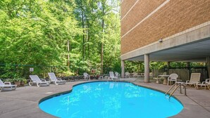 A swimming pool with lounge chairs and a 'No Diving' sign.