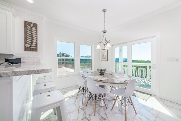 Enjoy meals in the kitchen with a view of the lush landscape through the large window.