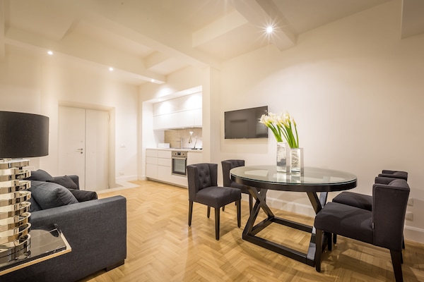 The living room with a sofa bed and the modern kitchenette