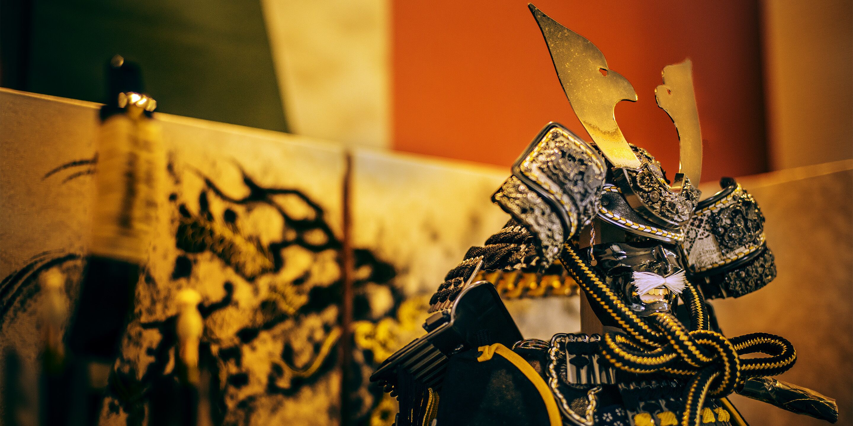 A close-up of a decorative object with intricate designs and a prominent golden element.