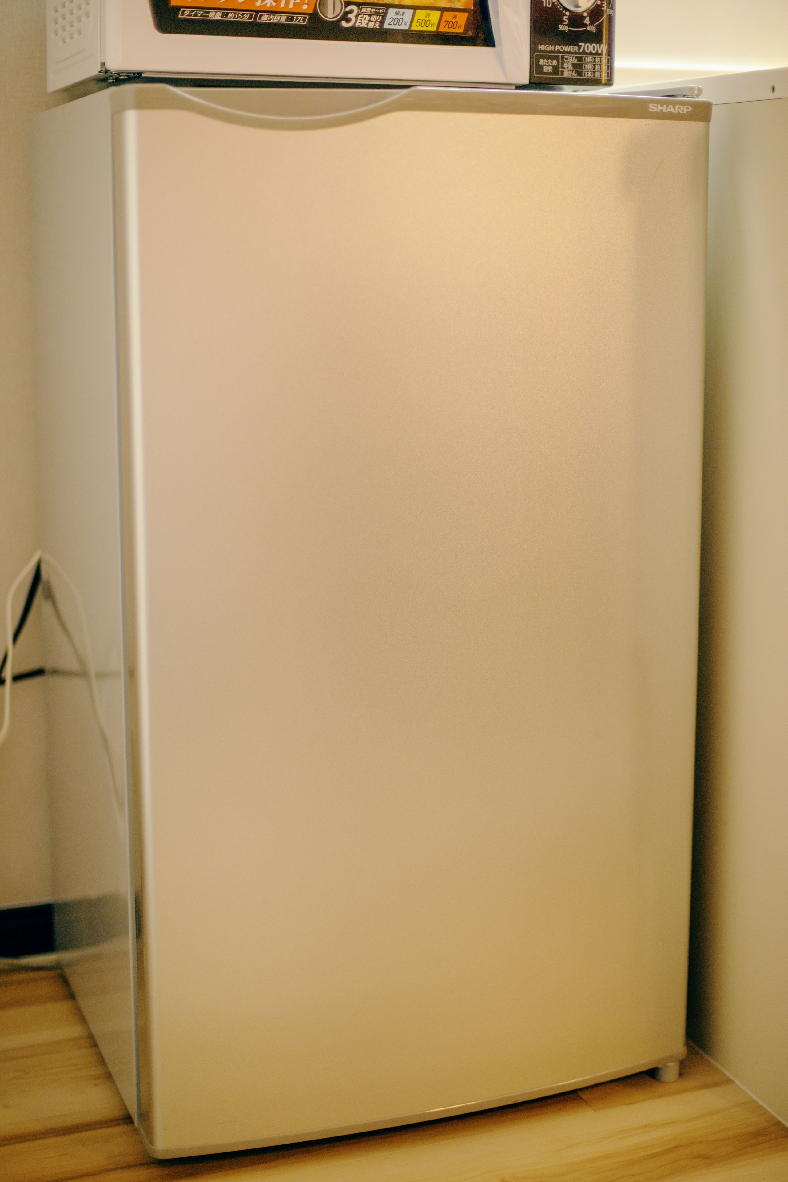 A white refrigerator with a box on top.