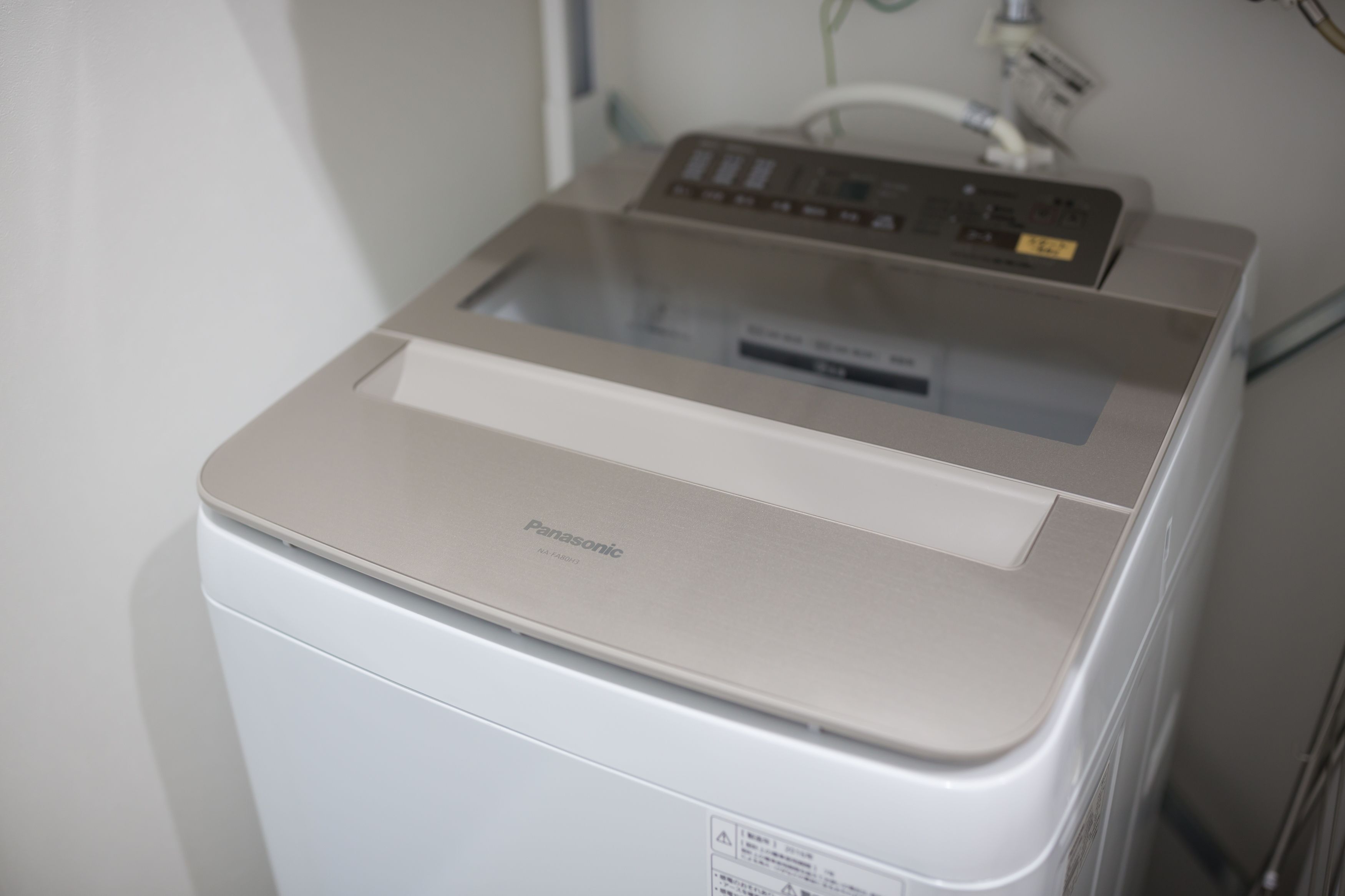 A Panasonic printer in a room with white walls and a visible electrical outlet.