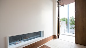A room with a large window, a wooden floor, and a door leading outside. - The Pool Resort Villa ICHIGOICHIE (Onna)