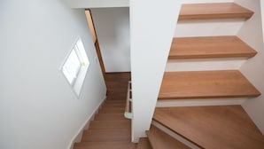 A staircase with wooden steps and a white wall. - The Pool Resort Villa ICHIGOICHIE (Onna)