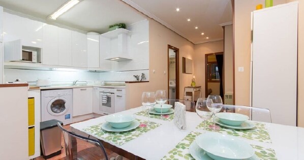 Enjoy meals in this well-equipped kitchen and dining area, featuring an oven and table for four.