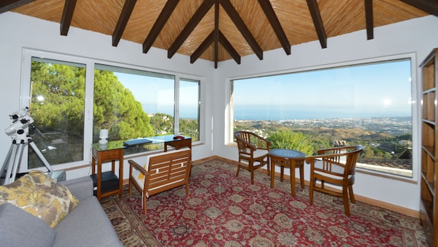 A room with large windows, a telescope, a sofa, and a wooden ceiling. - Villa with stunning panoramic views to the sea, privacy and swimming pool (Mijas)