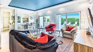 A spacious living area with a high ceiling, a dining area, and a view of the outdoors. - Villa Sole - five bedrooms with sea views and a private pool by MyWaycation (Poljane)
