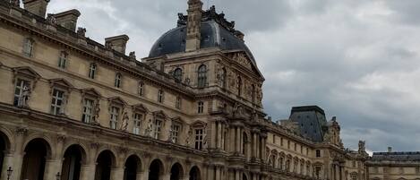A historic building with classical architecture, featuring a large dome and multiple arches.
