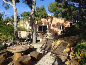 Relax in a serene outdoor space surrounded by lush greenery and a stone wall.