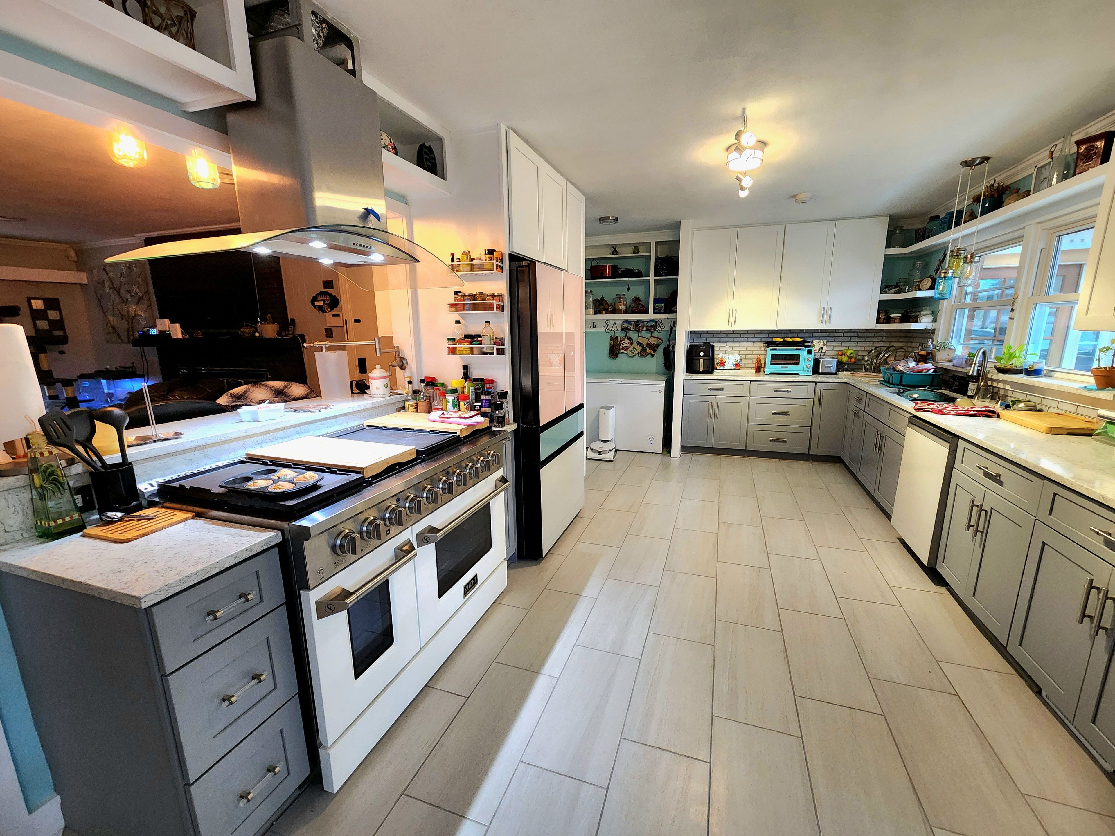 A modern kitchen with a central island, built-in appliances, and ample storage.