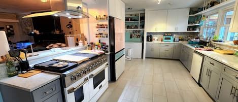 A modern kitchen with a central island, built-in appliances, and ample storage.