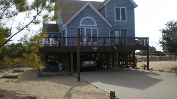 A two-story house with a covered porch and a garage. - Pet friendly  See specials in the description section (Nags Head)