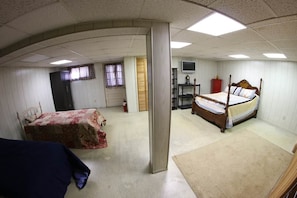 Un dormitorio con cama, mesita de noche, televisor y armario.
