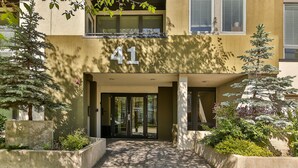 A building entrance with the number 41, a concrete pathway, and surrounding greenery. - Modern open concept, close to DT and Free UG Parking. Discounted Monthly Rate. (Calgary)
