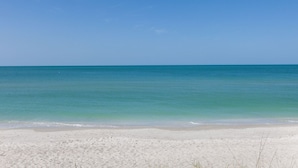 Una playa con agua turquesa cristalina y arena blanca.