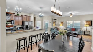 Relax in this inviting living area with a large dining table and comfortable seating.