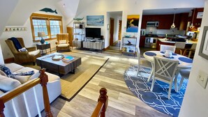 A spacious living room with a high ceiling, a dining area, and a kitchen. - Madaket Beach House- Walk to Beach- Private Nantucket Home. (Nantucket)