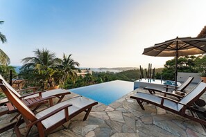 An infinity pool, sun loungers