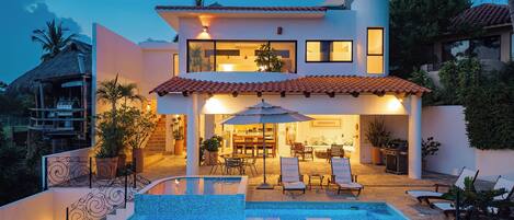 An infinity pool, sun loungers
